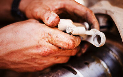 hands working on car parts