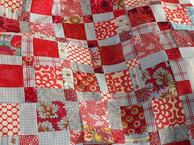 Red and white blocks for a quilt under construction.