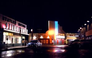 Statler Studebaker, Louis Watch Maker, Town Theater and Holt's Diner by night