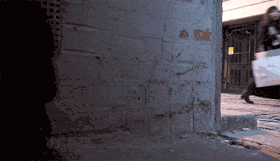 riottech: spray-painting a wall with invisible colour, laser writing being beamed and quickly vanishing
