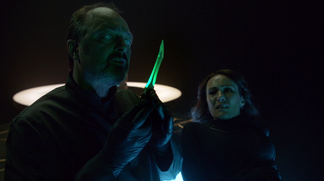 File:Astra's associate inspects the Green Kryptonite dagger.png