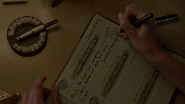 File:Gillian signs Jimmy's cheque.jpg