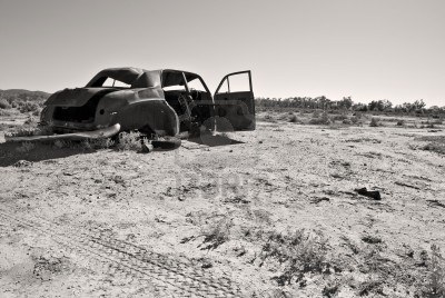 3228803-black-and-white-image-of-an-old-rusty-car-in-the-desert