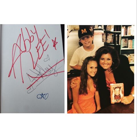 File:Abby Lee scratching out Haleys signature in book signing.jpg
