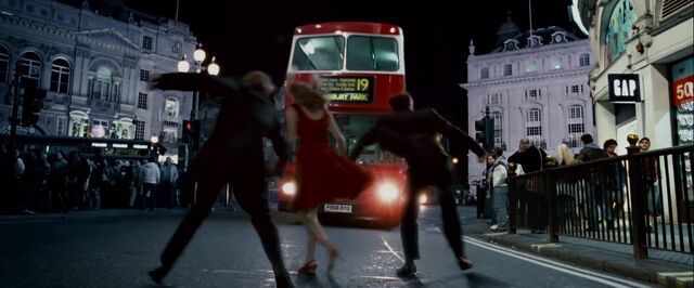 File:DH trailer2 Trio in front of a bus.jpg
