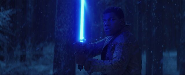 File:Finn Holding Lightsaber.jpg
