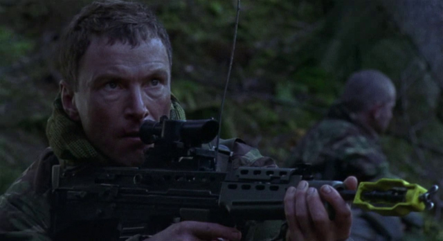 File:Bruce holding his gun.png