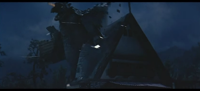 File:Baragon Destroys a House.png