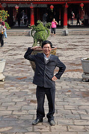 Asian-man-waving-n-smiling-big