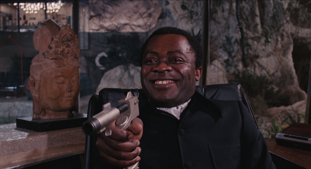 File:Live and Let Die - Kananga threatens Bond with his own weapon.png