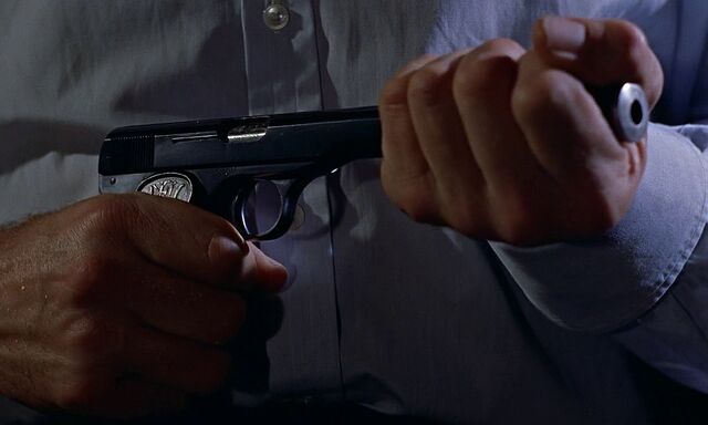File:Bond puts suppressor onto Model 1910.jpg