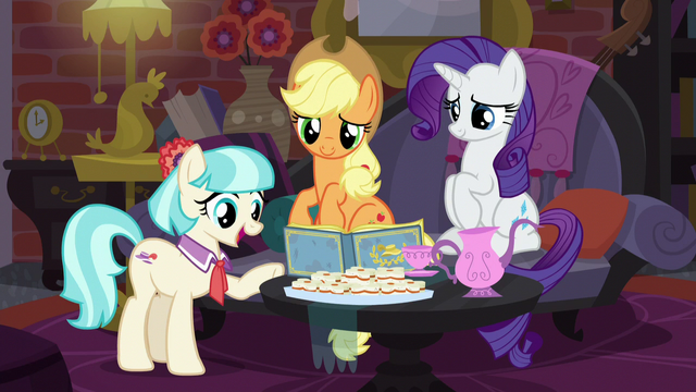 File:Coco points to photo of Charity Kindheart S5E16.png