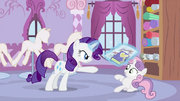 Rarity showing newspaper and her diary to Sweetie Belle S2E23.png