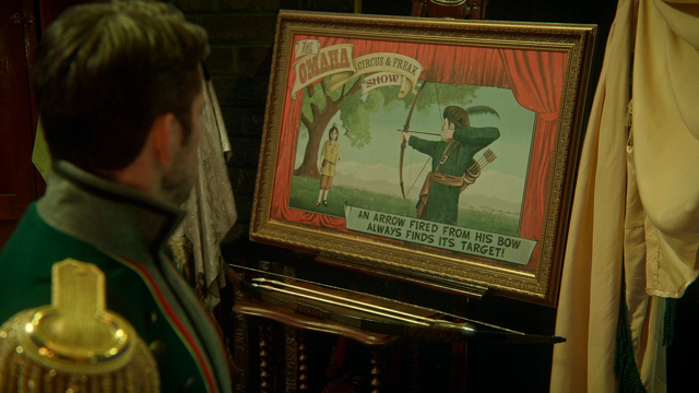 Fichier:4x17 Robin de Locksley des Bois affiche pancarte tableau arc magique flèches d'or dorées.png