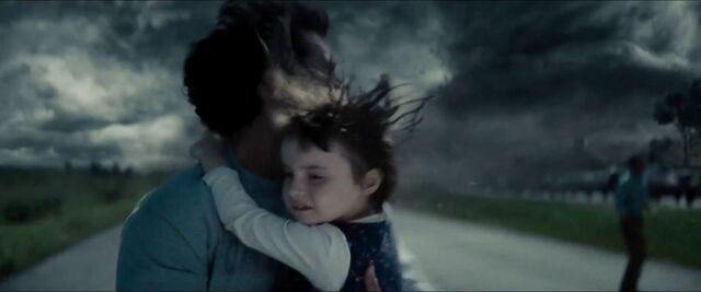 File:Man-of-Steel-Trailer-Images-Clark-Kent-Escaping-Tornado-with-Child-In-Arms.jpg