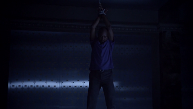 Datei:Teen Wolf Season 3 Episode 7 Currents Seth Gilliam Deaton hanging.png