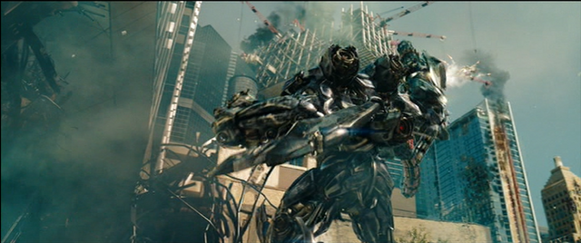 File:Dotm-shockwave-film-shootingatoptimusprime.png
